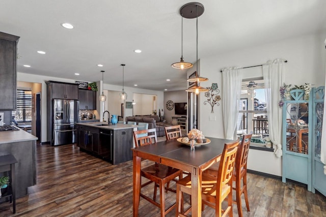 dining room with dark wood-style floors, baseboards, and recessed lighting