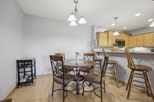 dining space with baseboards, light wood-style flooring, and recessed lighting