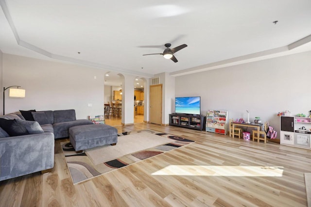 living room featuring visible vents, ceiling fan, and wood finished floors