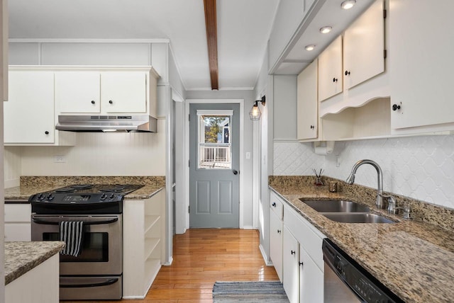 kitchen with under cabinet range hood, appliances with stainless steel finishes, open shelves, and a sink