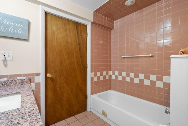 full bathroom with vanity, shower / bathing tub combination, tile patterned flooring, and tile walls