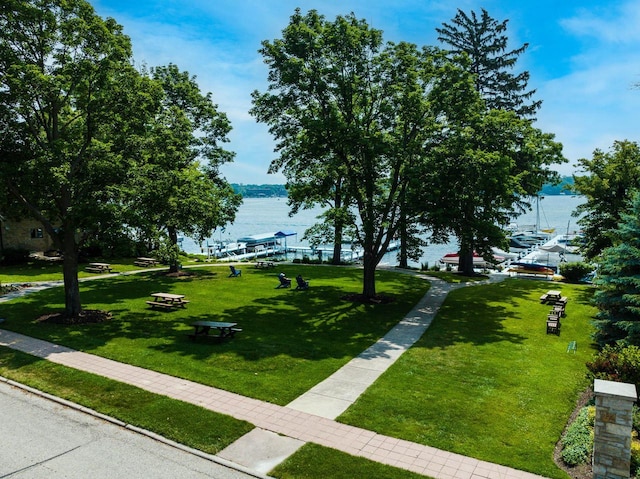 view of community with a water view and a yard