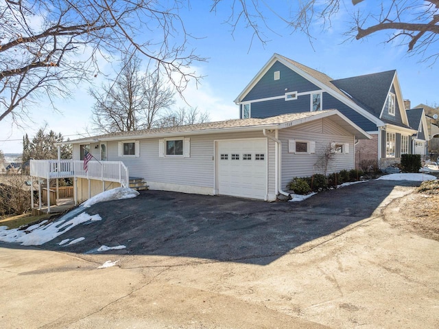 view of front of property with aphalt driveway and an attached garage