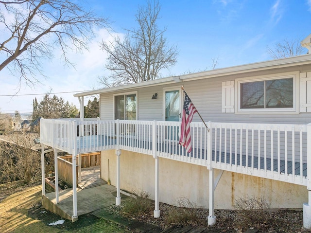 back of house with a deck