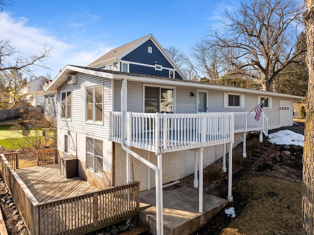 rear view of property featuring a wooden deck