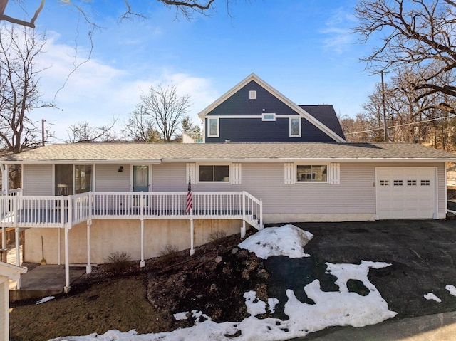 view of front of home featuring a garage and aphalt driveway