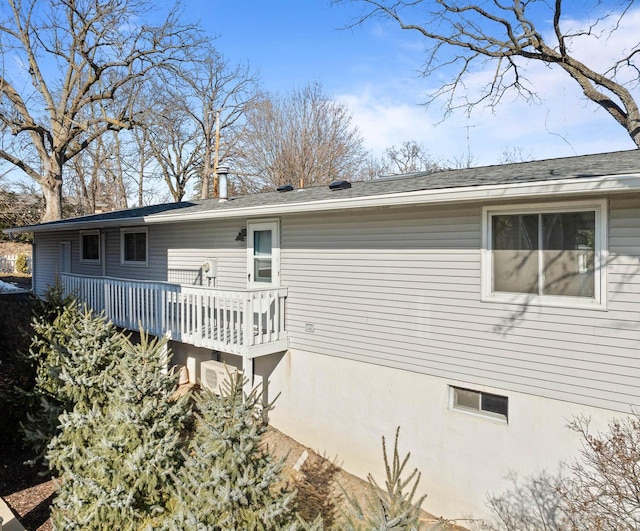 rear view of house with a wooden deck