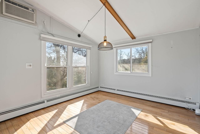 empty room with a baseboard heating unit, an AC wall unit, vaulted ceiling, and hardwood / wood-style floors