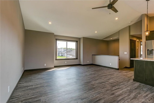 spare room with lofted ceiling, ceiling fan, recessed lighting, dark wood-type flooring, and baseboards