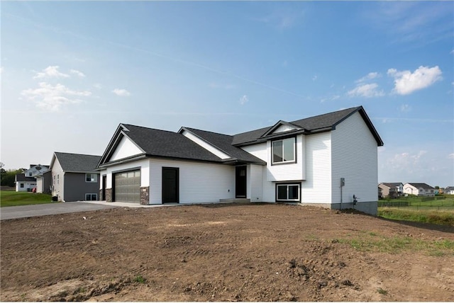 view of front of property with driveway and an attached garage