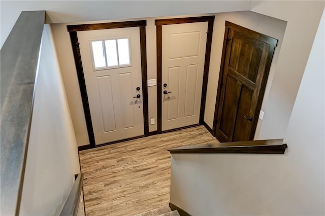 entryway with baseboards and light wood-style floors