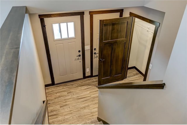 foyer featuring light wood-style floors and baseboards