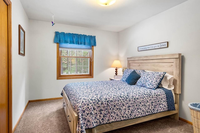 bedroom with carpet floors and baseboards