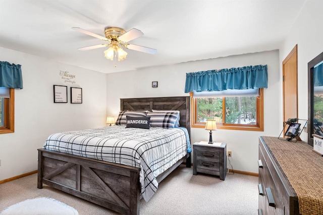 bedroom with baseboards, ceiling fan, and light colored carpet