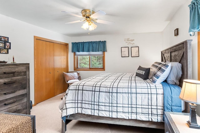 carpeted bedroom featuring a ceiling fan and a closet