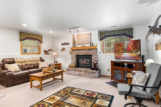 carpeted living room featuring a brick fireplace, baseboards, visible vents, and recessed lighting