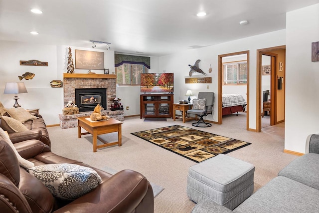 carpeted living room featuring a fireplace, baseboards, and recessed lighting