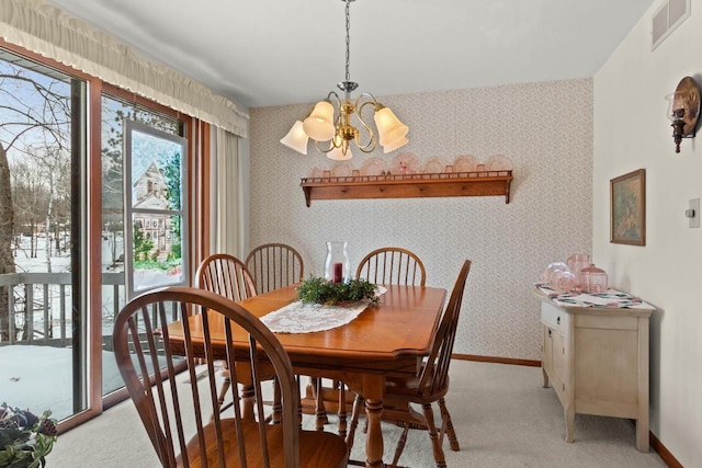 dining space featuring visible vents, a notable chandelier, baseboards, and wallpapered walls