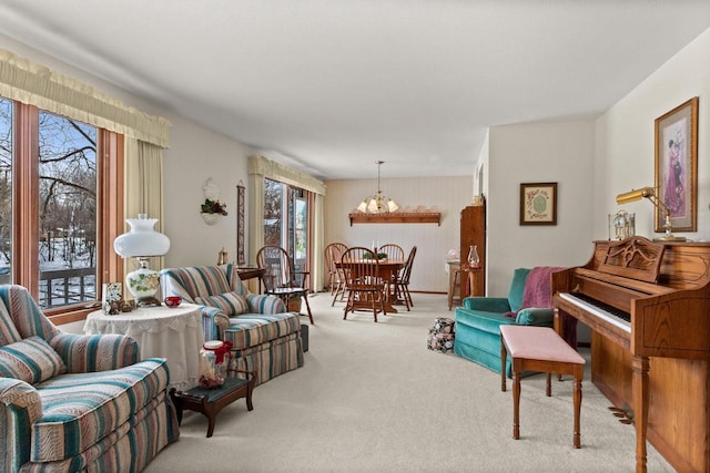 carpeted living room with a chandelier