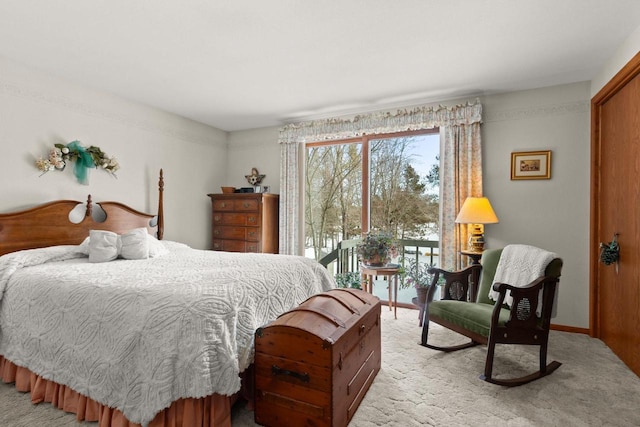 bedroom with baseboards, access to outside, and light colored carpet