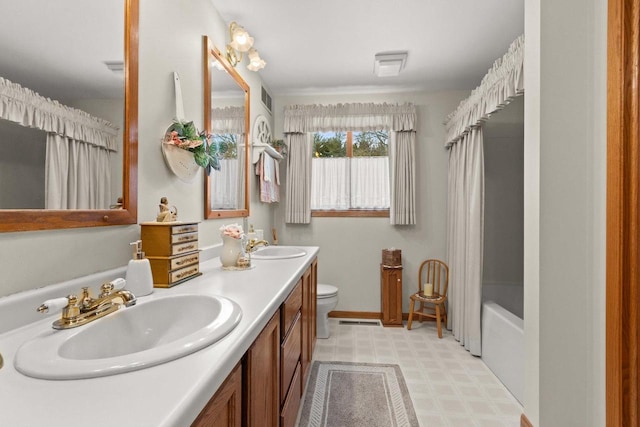 bathroom featuring double vanity, visible vents, toilet, tile patterned floors, and a sink