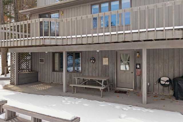 doorway to property featuring board and batten siding and a deck