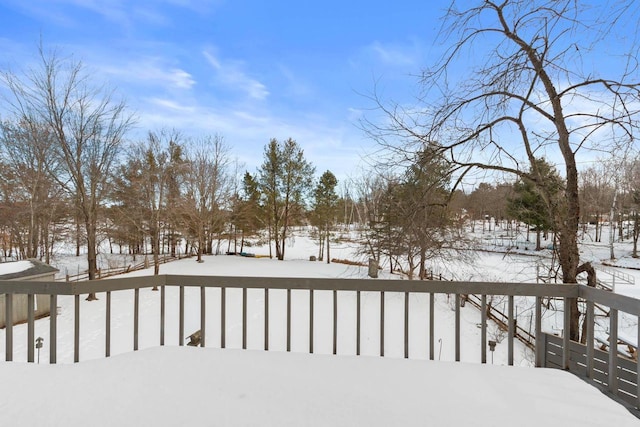 snowy yard with fence