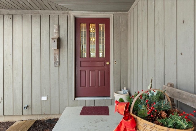 property entrance featuring board and batten siding