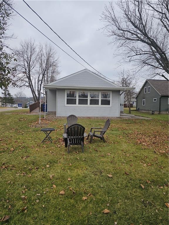 rear view of house with a yard