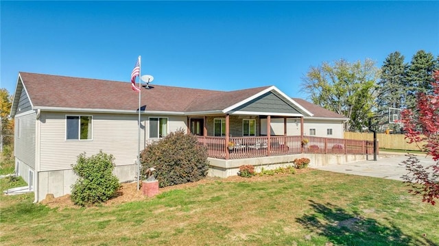 view of front facade with fence, a patio, and a front yard