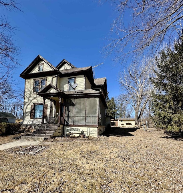 view of front of home featuring a sunroom