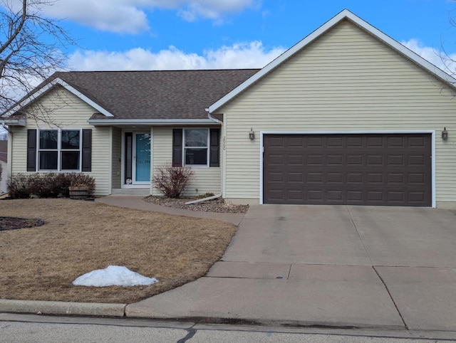 single story home with a garage, driveway, and roof with shingles