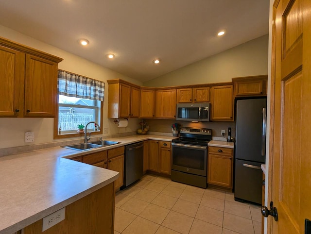 kitchen with light tile patterned floors, light countertops, appliances with stainless steel finishes, and a sink