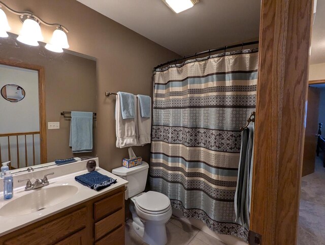 bathroom with toilet, a shower with curtain, tile patterned flooring, and vanity