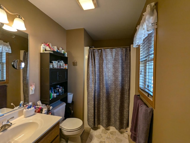 bathroom with toilet, curtained shower, and vanity