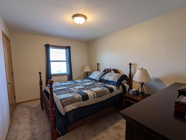 bedroom featuring a textured ceiling, baseboards, and light colored carpet