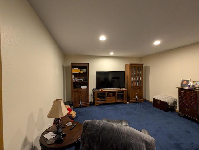 living area with dark colored carpet and recessed lighting