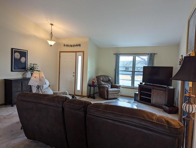 living room with carpet floors, lofted ceiling, and baseboards