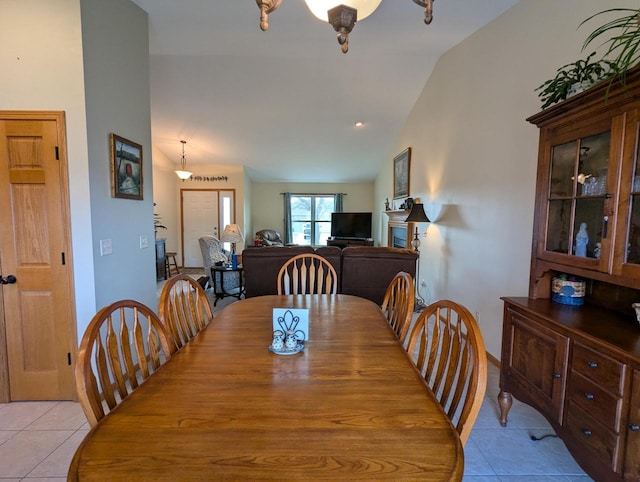 dining room with lofted ceiling and light tile patterned floors