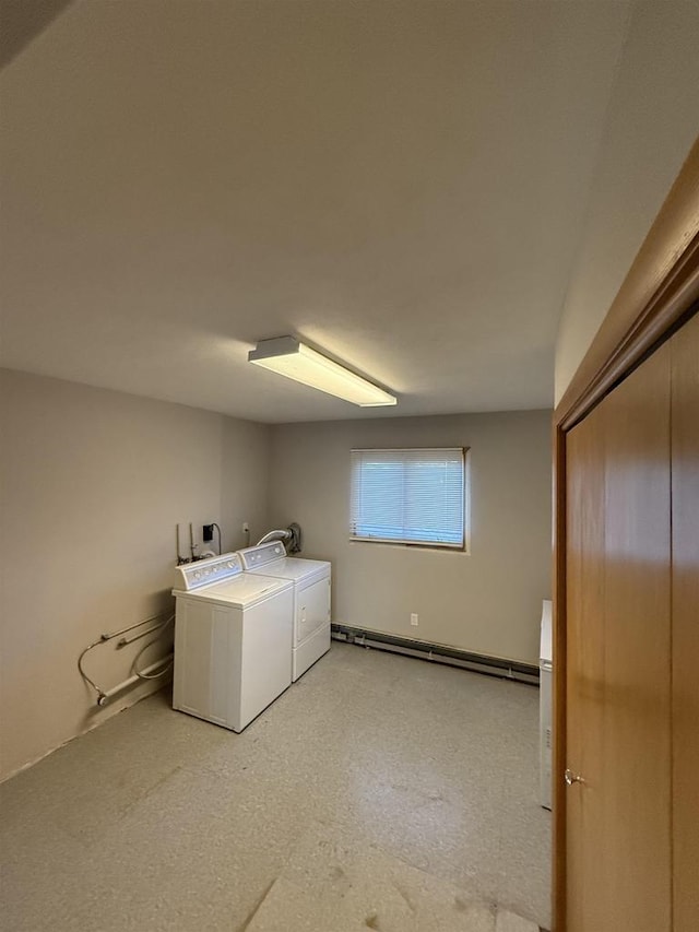 laundry area with laundry area, a baseboard heating unit, and washer and dryer