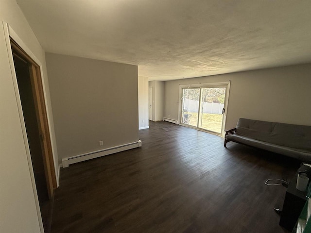 living area with a baseboard radiator, baseboards, and dark wood-type flooring