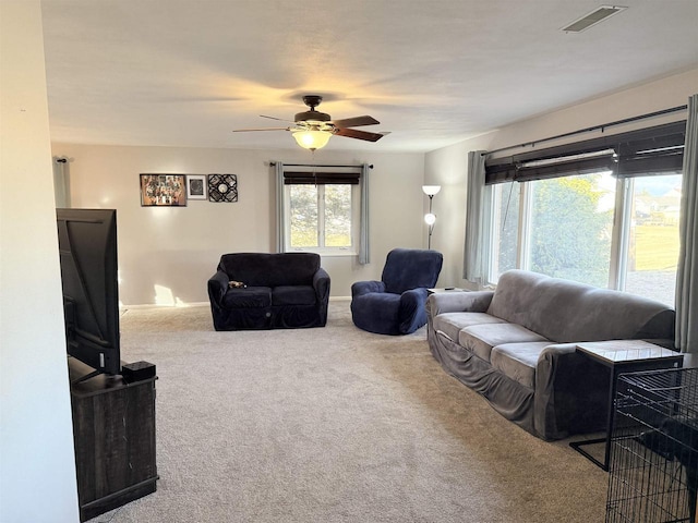 carpeted living room featuring ceiling fan and visible vents