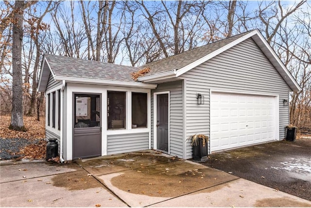 view of front of house featuring a sunroom and roof with shingles