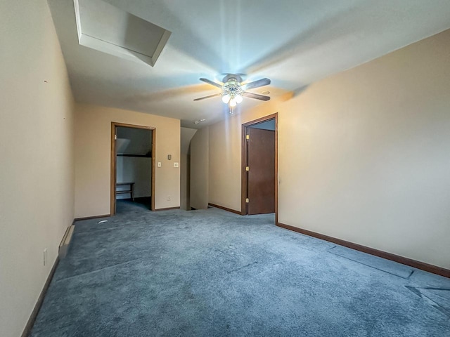 unfurnished bedroom featuring a ceiling fan, carpet flooring, attic access, and baseboards