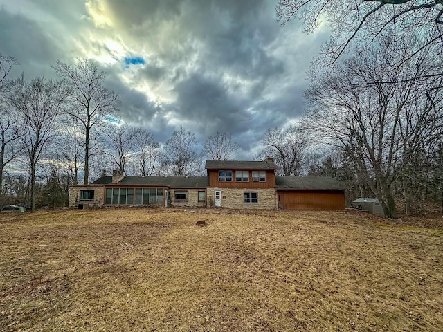 back of house with stone siding