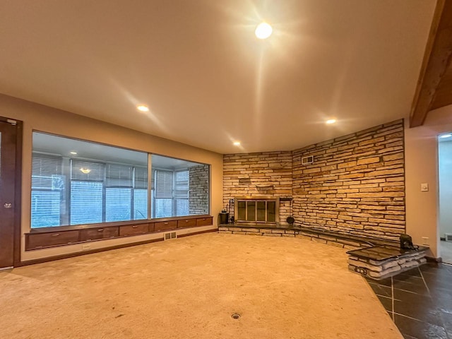 unfurnished living room featuring recessed lighting, visible vents, carpet flooring, and a stone fireplace