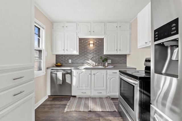 kitchen featuring dark wood-style floors, white cabinetry, stainless steel appliances, and a sink