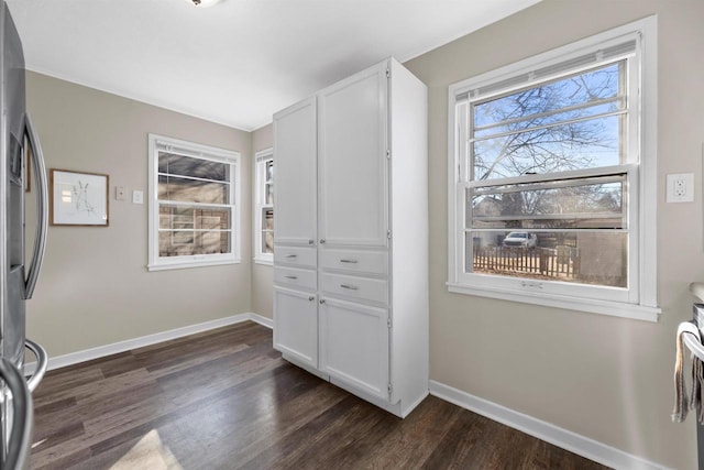 interior space with dark wood finished floors and baseboards