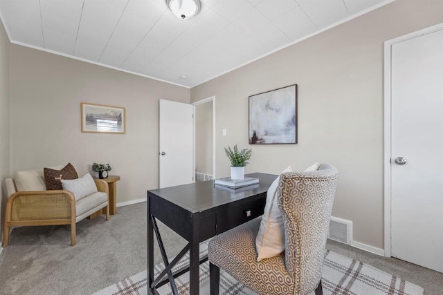 carpeted home office with baseboards, visible vents, and crown molding