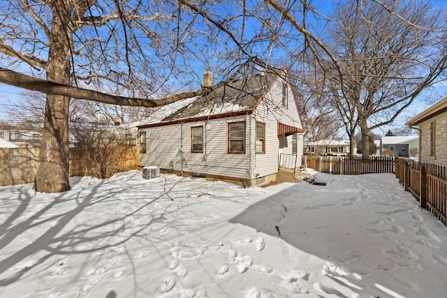 exterior space with fence private yard and a chimney